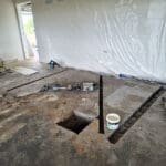Concrete slab cut open for electrical wiring during a Queenslander rewire